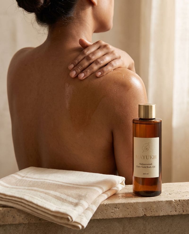 Nalpamaradi body oil smoothed over the shoulder after a bath